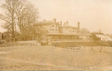 A postcard of the back view, including the gardens, taken around the same time